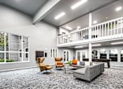 Thumbnail 6 of 15 - A spacious living room with a grey carpet and a balcony with white railings.