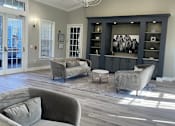 Thumbnail 1 of 13 - Clubhouse with a grey couch and a chandelier. at The Dawson Cartersville in Cartersville, GA 30191