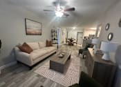 Thumbnail 2 of 13 - A living room with a couch, coffee table, and a ceiling fan. at The Dawson Cartersville in Cartersville, GA 30191