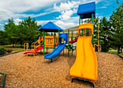 Thumbnail 8 of 13 - A playground with a yellow slide and a blue roofed structure. at The Dawson Cartersville in Cartersville, GA 30191