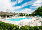 Thumbnail 6 of 13 - A pool surrounded by a white fence and green bushes. at The Dawson Cartersville in Cartersville, GA 30191