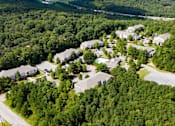 Thumbnail 10 of 13 - A bird's eye view of a residential area surrounded by dense green forest. at The Dawson Cartersville in Cartersville, GA 30191