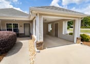 Thumbnail 24 of 31 - a house with a concrete driveway