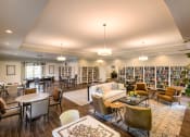 Thumbnail 5 of 31 - a resident clubhouse with couches chairs and tables