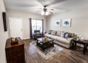 Thumbnail 14 of 31 - a living room with hardwood floors and a ceiling fan