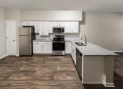 Thumbnail 25 of 31 - a kitchen with white cabinets and stainless steel appliances