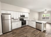 Thumbnail 26 of 31 - a kitchen with white cabinets and stainless steel appliances