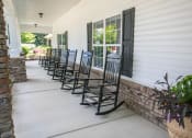Thumbnail 3 of 31 - front porch of clubhouse with rocking chairs