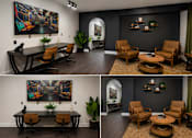 Thumbnail 26 of 43 - A living room with a black wall and a painting on it.