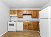 Thumbnail 1 of 9 - a kitchen with white appliances and wooden cabinets at Eagle Pointe New London, CT, 06320