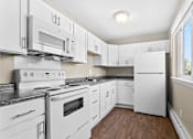Thumbnail 4 of 12 - a white kitchen with white appliances and white cabinets at Rose Hill Estates, Norwich, CT, 06360
