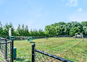 Thumbnail 9 of 12 - a park with a playground and a chain link fence at Rose Hill Estates, Norwich, CT, 06360