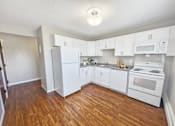 Thumbnail 3 of 12 - A kitchen with white appliances and wooden floors at Rose Hill Estates, Norwich, CT, 06360