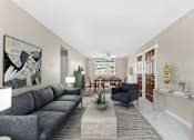 Thumbnail 1 of 12 - A living room with a grey sofa and a painting on the wall at Rose Hill Estates, Norwich, CT, 06360