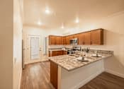 Thumbnail 29 of 94 - A Kitchen with Granite Countertop at The Villas at Ellis Manor, Fresno, 93720