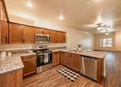 Thumbnail 44 of 94 - A Kitchen with Wooden Cabinets at The Villas at Ellis Manor, Fresno