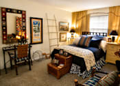 Thumbnail 13 of 15 - A bedroom with a bed, dresser, and chair.
