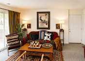Thumbnail 15 of 15 - A living room with a couch, chair, and a painting on the wall.