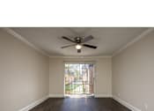 Thumbnail 17 of 17 - A room with a ceiling fan and sliding glass door.