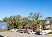 Thumbnail 15 of 17 - A parking lot in front of a building with a sign that says "Cypress Magnolia".