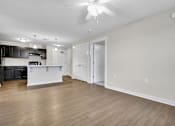 Thumbnail 1 of 25 - A spacious kitchen with a white countertop and a ceiling fan.
