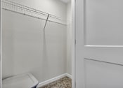 Thumbnail 20 of 25 - A white closet with a toilet in the corner.