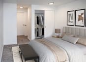 Thumbnail 9 of 19 - A bedroom with a large bed and a walk-in closet at Heritage Grove in Renton.