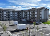 Thumbnail 7 of 36 - a large apartment building with a truck parked in a parking lot at Yellowstone Landing, Montana