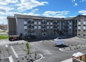 Thumbnail 8 of 36 - an empty parking lot in front of an apartment building at Yellowstone Landing, Montana, 59714