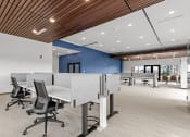 Thumbnail 22 of 36 - a large office space with desks and chairs and a blue wall at Yellowstone Landing, Montana