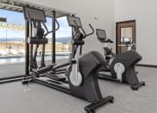 Thumbnail 30 of 36 - a row of treadmills in a gym next to a pool at Yellowstone Landing, Montana, 59714