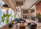 Thumbnail 24 of 26 - a lobby with couches and chairs and a large window