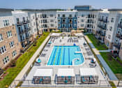 Thumbnail 23 of 26 - an aerial view of an apartment building with a swimming pool