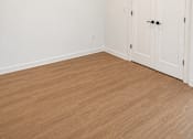 Thumbnail 9 of 14 - Empty bedroom with wood flooring and double doors at Textile Lofts Apartments, Cincinnati, 45202