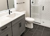 Thumbnail 2 of 14 - Modern bathroom with white subway tile shower at Textile Lofts Apartments, Ohio, 45202