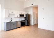 Thumbnail 11 of 14 - Open concept kitchen with two tone cabinets at Textile Lofts Apartments, Cincinnati, 45202