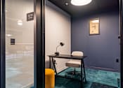 Thumbnail 2 of 5 - a desk with a chair and a lamp in a room with a door