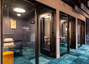 Thumbnail 1 of 5 - a conference room with glass doors and a blue rug