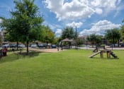Thumbnail 6 of 43 - a park with a picnic area and a playground at Discovery at Craig Ranch, Texas