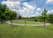 Thumbnail 7 of 43 - a park with trees and a circular walkway at Discovery at Craig Ranch, McKinney, TX