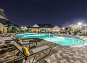 Thumbnail 18 of 38 - a swimming pool at night with chairs around it  at Waterstone at Cinco Ranch, Texas