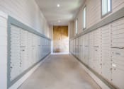 Thumbnail 19 of 43 - a row of lockers in a long room with a stone wall at Discovery at Craig Ranch, McKinney, Texas