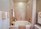 Thumbnail 65 of 84 - a bathroom with a large soaker tub and matching towels  at Grand Villas Apartments, Katy, TX