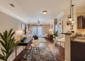 Thumbnail 73 of 84 - a living room with a kitchen and a dining room  at Grand Villas Apartments, Texas