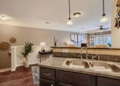 Thumbnail 78 of 84 - a kitchen with a sink and a counter top  at Grand Villas Apartments, Texas, 77494