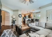 Thumbnail 57 of 84 - a living room with a couch and a table at Grand Villas Apartments, Texas