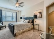 Thumbnail 62 of 84 - bedroom area with bed, walk-in closet and other furniture at Grand Villas Apartments, Texas