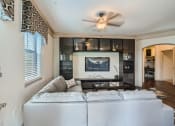 Thumbnail 76 of 84 - a living room with a white couch and a tv  at Grand Villas Apartments, Texas, 77494