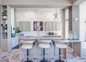 Thumbnail 23 of 43 - a white kitchen with a bar and white counter tops at Discovery at Craig Ranch, McKinney, Texas