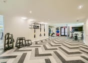 Thumbnail 9 of 24 - the gym in the house has a checkered floor and weights on the wall at Imperial Lofts, Sugar Land, Texas